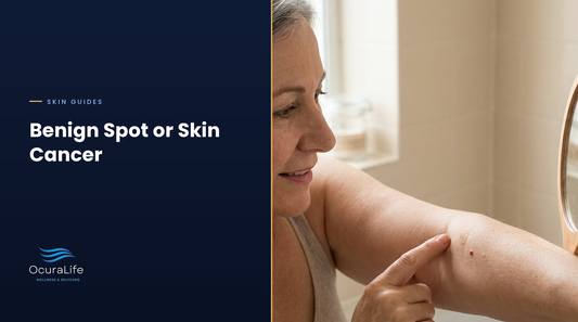 Woman in her fifties checking a small red dot and a light-brown spot on her upper arm in a bathroom mirror
